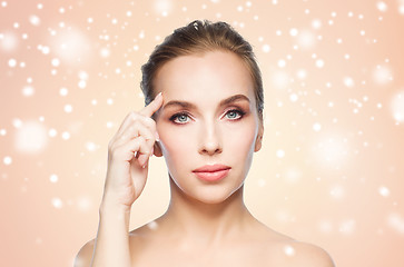 Image showing beautiful woman showing her forehead over snow
