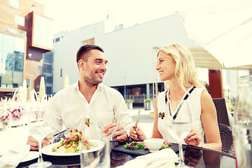 Image showing happy couple eating dinner at restaurant terrace