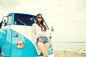 Image showing smiling young hippie woman with minivan car