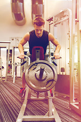 Image showing young man exercising on t-bar row machine in gym