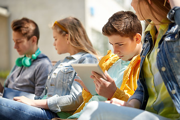 Image showing friends or students with tablet pc outdoors