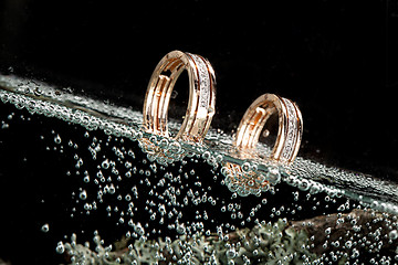 Image showing Golden Rings In The Water