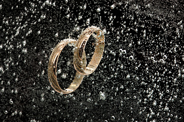 Image showing Golden Rings In The Water