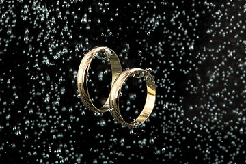 Image showing Golden Rings In The Water