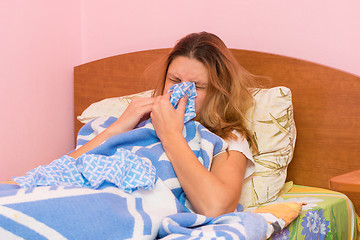 Image showing She sneezes ill with acute respiratory illness