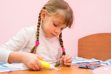 Image showing Girl Apply glue to the crafts out of colored paper