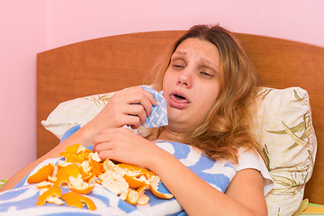 Image showing Young girl coughing heavily lying in bed