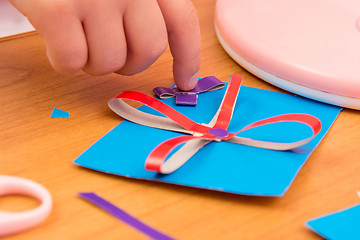 Image showing The child sticks to the bow Crafts for mom, close up