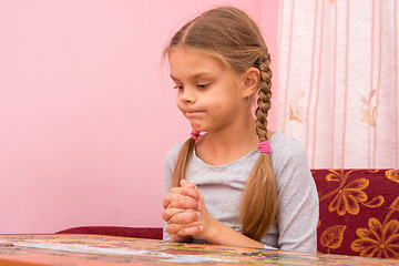 Image showing Girl funny thought pouting cheeks collecting picture of puzzles