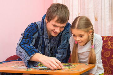 Image showing Pope shows daughter how to assemble a picture from puzzles