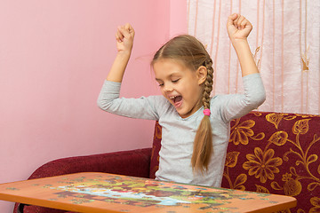 Image showing Girl is happy to have found the item you want the puzzle