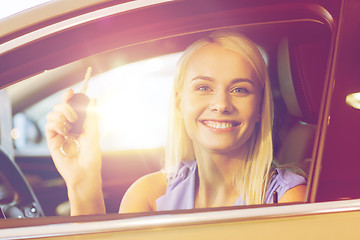 Image showing happy woman getting car key in auto show or salon