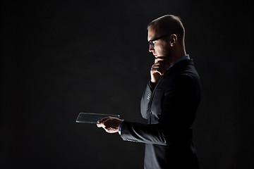 Image showing close up of businessman with transparent tablet pc