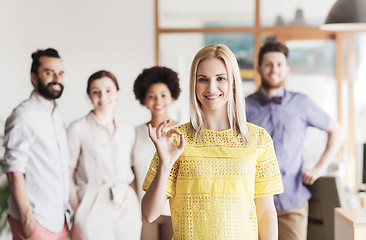 Image showing happy woman showing ok over creative office team