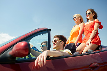 Image showing happy friends driving in cabriolet car