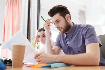 Image showing creative team with computer and papers in office