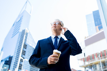 Image showing senior businessman calling on smartphone in city