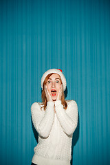 Image showing Surprised christmas girl wearing a santa hat