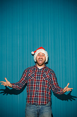 Image showing Smiling christmas man wearing a santa hat