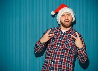 Image showing The opinionated christmas man wearing a santa hat