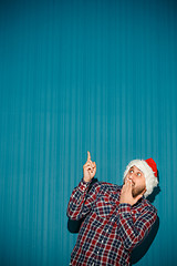 Image showing frightened christmas man wearing a santa hat