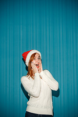 Image showing Surprised christmas girl wearing a santa hat