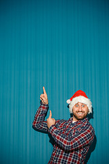 Image showing Smiling christmas man wearing a santa hat