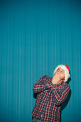 Image showing frightened christmas man wearing a santa hat