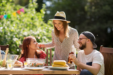 Image showing happy friends having dinner at summer garden party