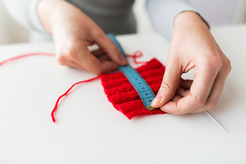 Image showing woman with knitting on needle and measuring tape