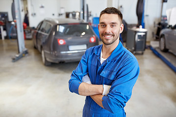 Image showing happy auto mechanic man or smith at car workshop