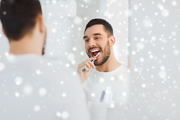 Image showing man with toothbrush cleaning teeth at bathroom