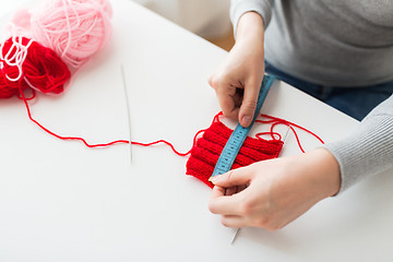 Image showing woman with knitting, needles and measuring tape