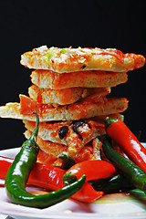 Image showing Pizza and chili against dark background