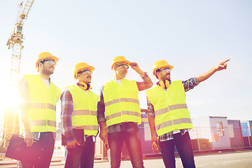 Image showing group of smiling builders with tablet pc outdoors