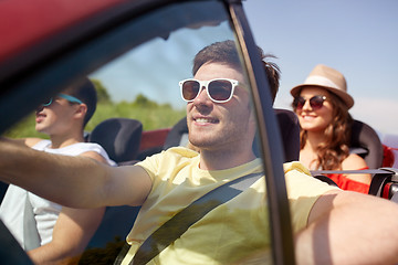 Image showing happy friends driving in cabriolet car