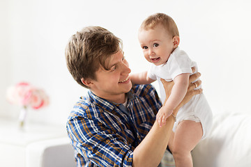 Image showing happy young father with little baby at home