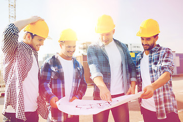 Image showing group of builders with tablet pc and blueprint