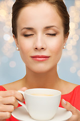 Image showing close up of woman in red with coffee cup 