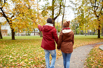 Image showing happy young couple walking in autumn park