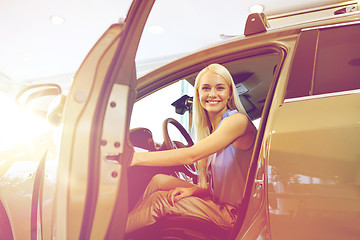 Image showing happy woman inside car in auto show or salon