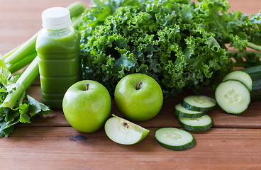 Image showing close up of bottle with green juice and vegetables