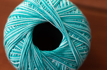 Image showing close up of turquoise knitting yarn ball on wood