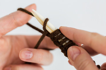 Image showing close up of hands knitting with needles and yarn