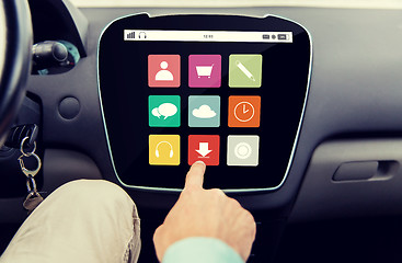 Image showing close up of hand and menu icons on car computer