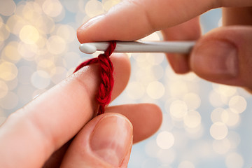 Image showing close up of hands knitting with crochet hook