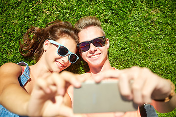 Image showing happy couple taking selfie on smartphone at summer