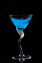 Image showing Cherry dropping into cocktail