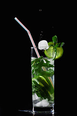 Image showing Ice-cube falling into mojito cocktail