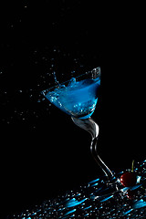 Image showing Blue cocktail splash and cherry